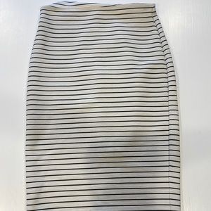 Cream high waisted pencil skirt with neon zipper detail in back. Size medium